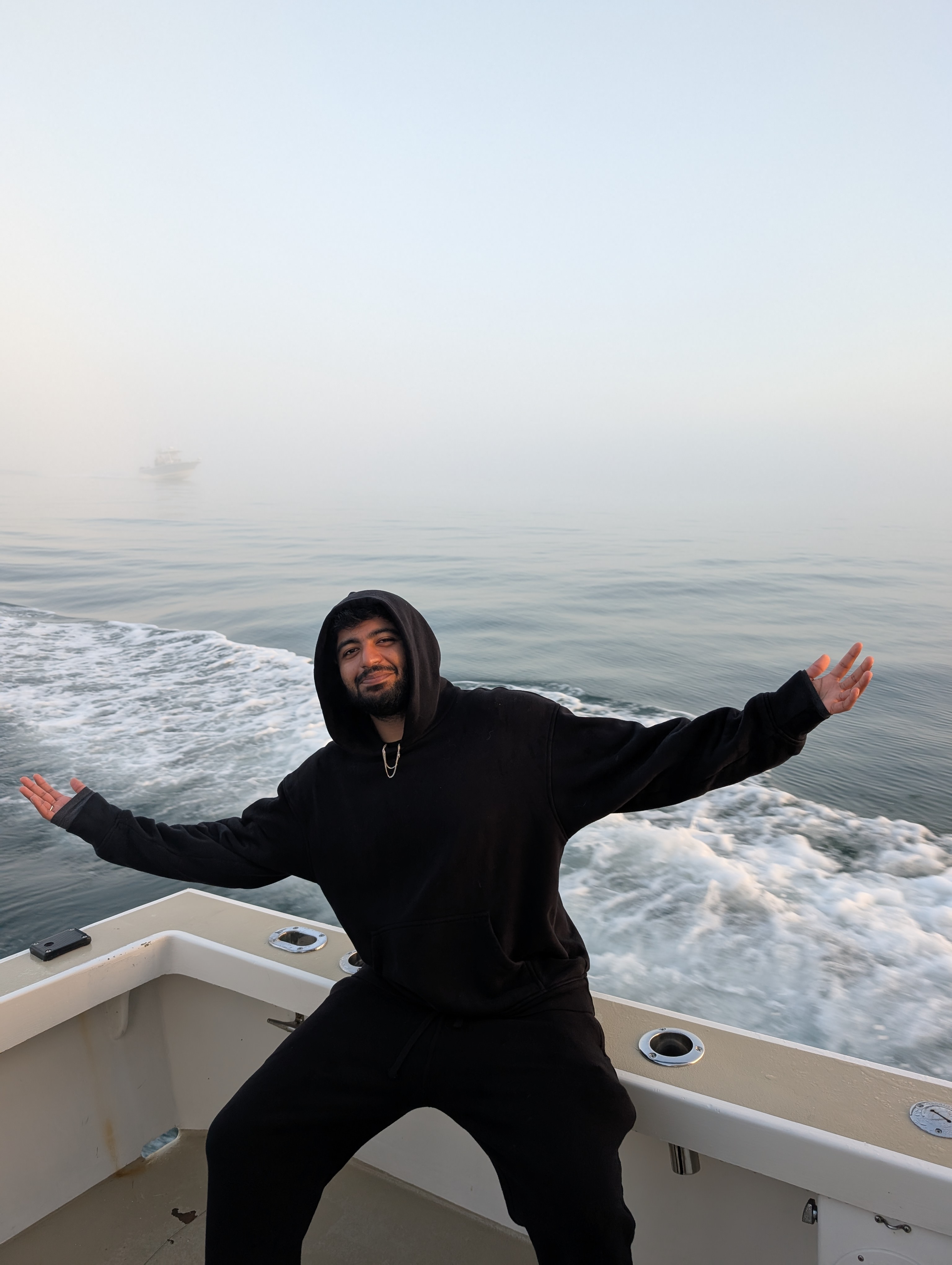 sick in a hoodie on a boat